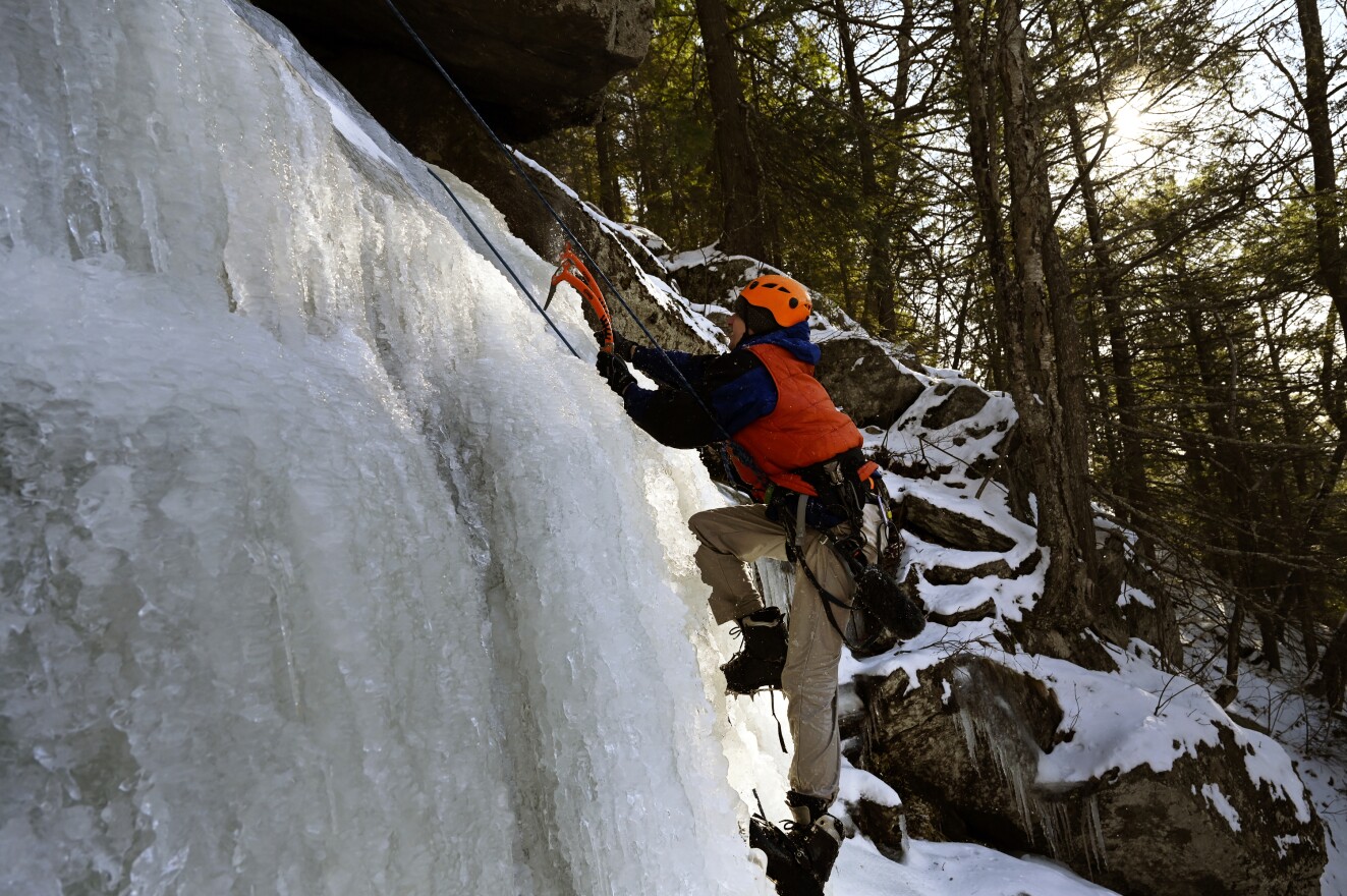 First-time ice climber and reporter Patrick Skahill, loaded with audio gear, has problems starting to snowball as his left boot begins to come off while he fails to gain purchase with ice tools during his ascent of an ice flow. Skahill was supported above by belayer Matt Conroy, who controlled the rope attached to Skahill to arrest any slips or falls. There were many. 